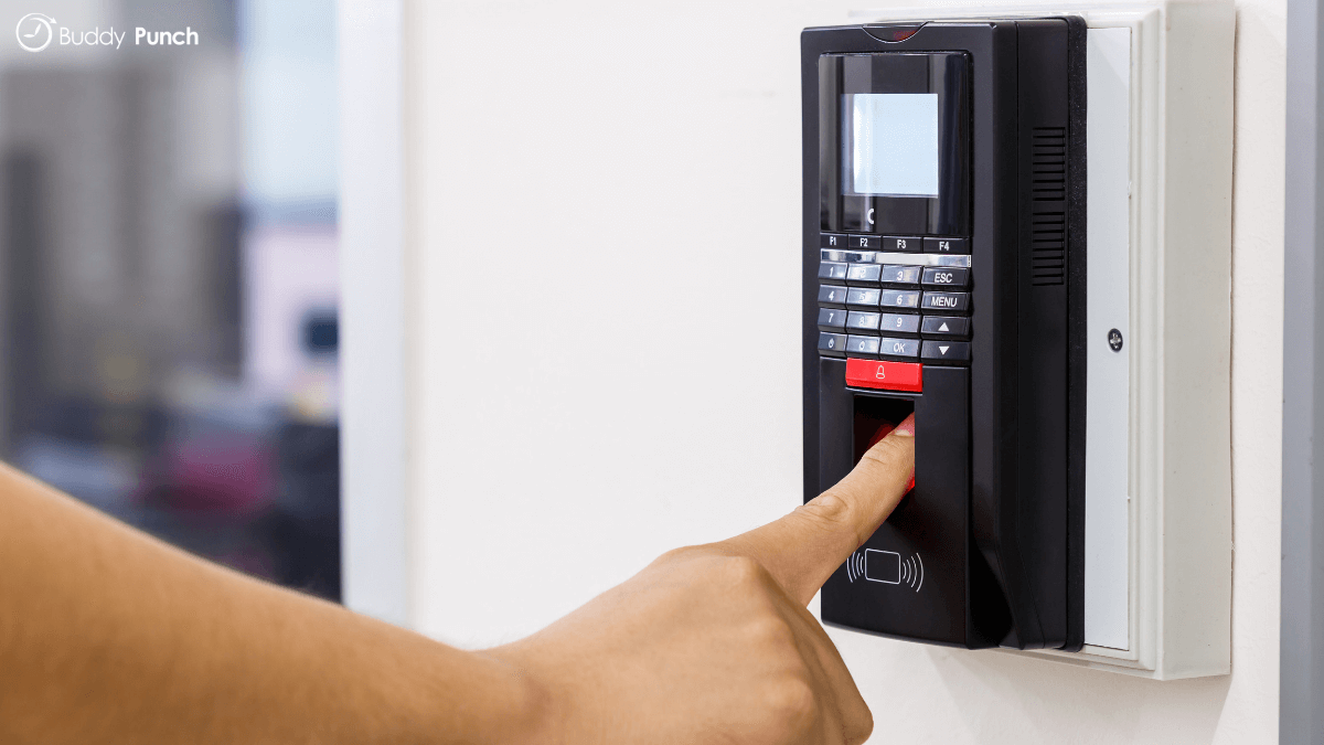 Employee using fingerprint biometric to punch time. 