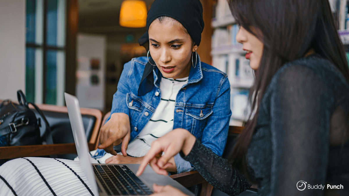 Employee and employer reviewing schedule together to ensure accuracy.