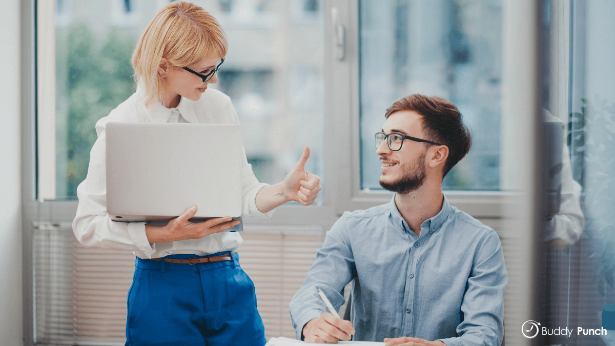 Manager providing feedback to an employee in a casual manner and setting.