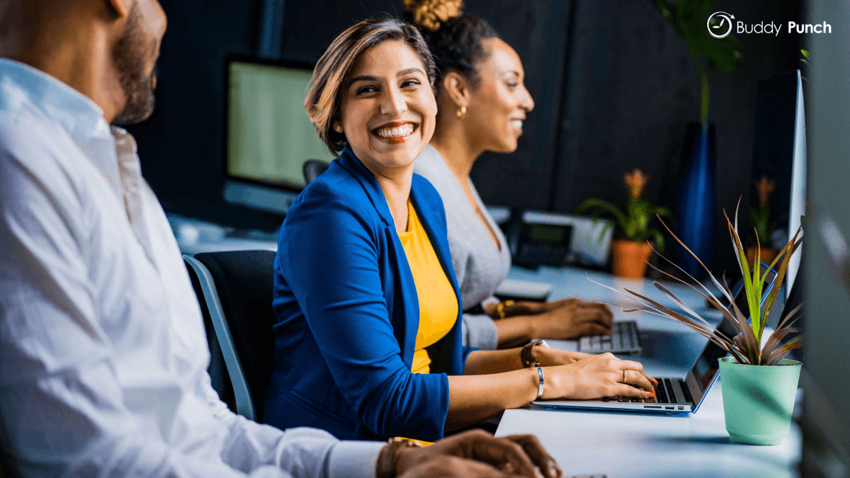 Happy employees conversing with one another. There is a high level of engagement between the two. 